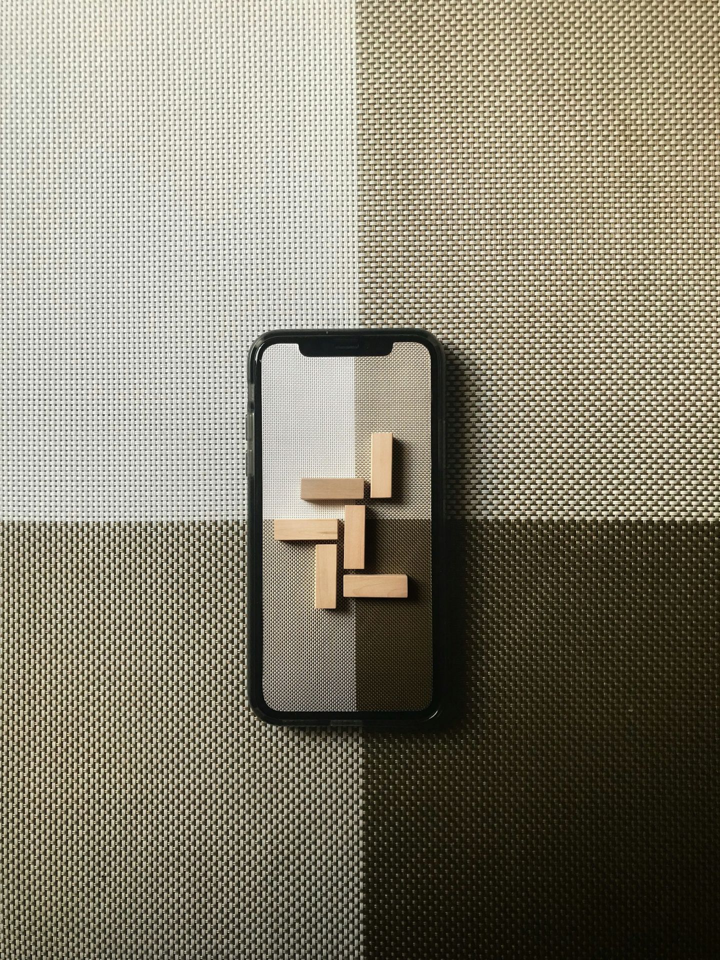 black iphone case on gray textile